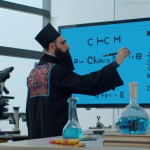 ابن سینا در یک آزمایشگاه مدرن و زیبا در حال انجام یک آزمایش به کمک یک ربات هوش مصنوعی است و اون ربات هم در حال یادداشت کردن معادلات شیمیایی بر روی تخته است.