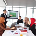 دورهمی مدیران خانم و آقا در سالن کنفرانس به صورتی که خانم ها با حجاب باشند
